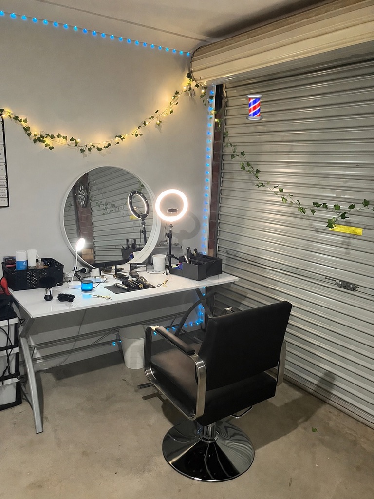 Luxury private barber studio with warm gold lighting